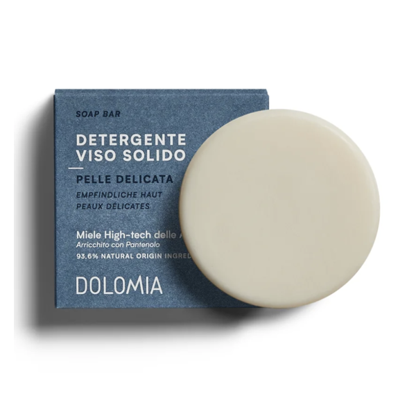 Dolomia-Phyto-defence-soap-bar.png Festes Gesichtsreinigungsmittel in einer runden Form auf einer blauen Verpackung mit Angaben für empfindliche Haut.